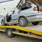 crashed-car-loading-into-tow-truck-after-traffic-accident-road_77190-9022-2